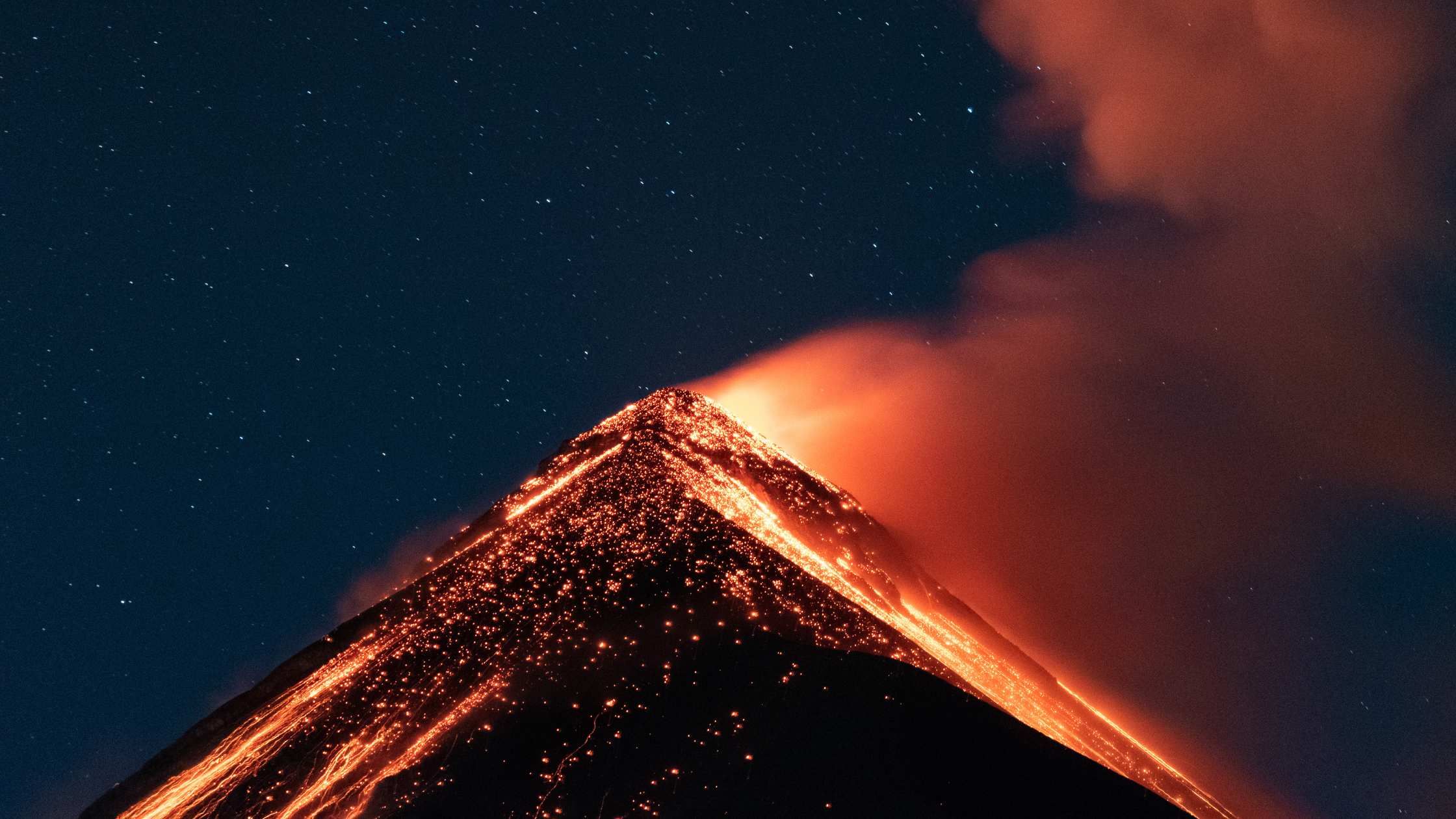 Here’s the English translation of the blog with images:

**Guatemala is known for its impressive volcanic geography. With over 30 volcanoes, many of them active, the country offers adventurers the chance to explore landscapes that seem otherworldly. From summiting peaks to enjoy breathtaking sunrises to witnessing live lava flows, Guatemala's volcanoes are a must-see for nature and adventure lovers. In this blog, we present some of the most impressive volcanoes in Guatemala that you can't miss.**

![2.jpg](https://s3.us-south.cloud-object-storage.appdomain.cloud/bucket-travelisimo/2_7644161980)

### 1. Volcán de Fuego: The Active Giant
The **Volcán de Fuego** is one of the most active volcanoes in Central America, and its constant activity makes it a fascinating spectacle. Located just 16 km from the colonial city of Antigua Guatemala, this volcano offers visitors a unique opportunity to witness eruptions from a safe distance. The ash and lava explosions light up the night sky, creating an unforgettable scene. For the more adventurous, it's possible to hike around the area, though the summit is too dangerous to climb due to the ongoing activity.

### 2. Volcán Acatenango: Unforgettable Sunrises
Next to Volcán de Fuego is **Volcán Acatenango**, offering one of the best hiking experiences in Guatemala. Climbing Acatenango is a challenging but rewarding trek that takes you up to 3,976 meters. Most excursions include a night of camping, where you can enjoy spectacular views of Fuego's eruptions. If you dare to reach the summit at sunrise, you'll be rewarded with a 360-degree panoramic view that spans the volcanic landscape and lowlands.

![5.png](https://s3.us-south.cloud-object-storage.appdomain.cloud/bucket-travelisimo/5_23ffd1fc09)

### 3. Volcán Pacaya: A Favorite Among Adventurers
One of the most accessible and popular volcanoes for tourists is **Volcán Pacaya**, located about an hour from Guatemala City. At an altitude of 2,552 meters, Pacaya has been in constant eruption since the 1960s, making it a must-see for those who want to witness lava up close. Hikes to Pacaya are moderate and suitable for most travelers. One of the most memorable experiences is roasting marshmallows on volcanic rocks heated by the lava. Plus, the lunar-like landscape surrounding the volcano is perfect for photographers.

![6.png](https://s3.us-south.cloud-object-storage.appdomain.cloud/bucket-travelisimo/6_889f9c9cbd)

### 4. Volcán Tajumulco: The Highest Point in Central America
At 4,220 meters above sea level, **Volcán Tajumulco** is the highest volcano not only in Guatemala but in all of Central America. For hiking enthusiasts, reaching the summit of Tajumulco is an epic experience. The hike lasts between 6 to 8 hours and can be done in one or two days, depending on your fitness level. From the summit, the views are simply breathtaking: if the weather is favorable, you can see the entire volcanic chain of Guatemala, and on clear days, even the Pacific and Atlantic Oceans. A once-in-a-lifetime adventure!

### 5. Volcán Santa María: Views of Erupting Santiaguito
Located near the city of Quetzaltenango, **Volcán Santa María** is famous for its beauty and for offering spectacular views of **Volcán Santiaguito**, one of the most active volcanoes in Guatemala. The hike to the top of Santa María is demanding, but the rewards are unparalleled: from the summit, you can observe the constant eruptions of Santiaguito, a smaller volcano that formed on the slopes of Santa María. This is a favorite destination for experienced hikers and photographers looking to capture unique images.

### 6. Volcán San Pedro: Guardian of Lake Atitlán
The **Volcán San Pedro**, located on the shores of the beautiful **Lake Atitlán**, offers a moderate hike that rewards you with stunning views of the lake and the surrounding towns. This 3,020-meter volcano is a perfect choice for those looking to enjoy the tranquility of nature while walking through lush, green trails. From the summit, you can enjoy a panoramic view of the lake, surrounded by other volcanoes such as **Volcán Tolimán** and **Volcán Atitlán**.

### 7. Volcán Atitlán: A Challenging Adventure
For the more experienced adventurers, **Volcán Atitlán** is one of the most challenging hikes in Guatemala. At 3,535 meters in altitude, this volcano offers a steep and technical ascent, but the views from the summit are incomparable. The hike typically lasts around 10 hours in total, but hikers who complete the ascent are rewarded with majestic views of Lake Atitlán and the surrounding volcanic landscape.

![3.jpg](https://s3.us-south.cloud-object-storage.appdomain.cloud/bucket-travelisimo/3_00f718a992)

### Tips for Adventurers
- **Equipment**: Always bring appropriate hiking gear, especially sturdy shoes, warm clothing for high altitudes, and sunscreen.
- **Local Guides**: Hiring experienced guides is recommended, as they know the routes and will ensure your safety during the ascent.
- **Permits**: Some volcanoes require permits for hiking, especially those located in national parks.

![4.jpg](https://s3.us-south.cloud-object-storage.appdomain.cloud/bucket-travelisimo/4_52f4faf59b)

Exploring Guatemala’s volcanoes will allow you to experience a unique blend of nature, history, and adventure! Each volcano has its own character and appeal, making this country a paradise for adventure tourism lovers. So lace up your hiking boots and get ready to explore these geological wonders!