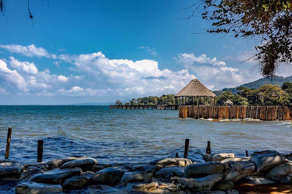 ## Lake Peten Itza

It is one of the tourist places of Petén. It is surrounded by a large tropical jungle, close to the Mayan archaeological sites. With 99 square kilometers, it is the third-largest natural lake in Guatemala, if what you like is the environment almost without human interruption, this is the right place to travel and recharge your energies. In it, you can stay to enjoy the wonders of the lake, such as boat rides, diving in some of its beaches. The viewpoints of restaurants and cafes on the shores of the lake are ideal if you are looking for romantic destinations in Guatemala.

![Logo Peten Itza.jfif](https://cdn.travelisimo.com/Logo_Peten_Itza_33ffa2a3b3)

## Grutas de Lanquín National Park

The department of Alta Vera Paz is one of the most beautiful places in Guatemala because it has unusual natural beauty. There is this park. Specifically 1,000 meters from the town of Lanquìn. This place is ideal if you are looking for tranquility, but also an extreme and unusual adventure. Remember to always wear adequate equipment since the place is quite humid and cold.

![Parque Nacional Grutas de Lanquín.jpg](https://cdn.travelisimo.com/Parque_Nacional_Grutas_de_Lanquin_a9153ce793)

## San Felipe Castle

Perhaps the most striking thing about the current building is the Bustamante tower where you can see 19 cannons: two bronze and 17 iron, as well as other objects such as wagon wheels from the time. It is also recommendable to visit the warehouses where the products that were traded with Spain were stored. It is ideal for those who are looking for a historical trip and learn about the origins of the region.

![Castillo de San Felipe.jpg](https://cdn.travelisimo.com/Castillo_de_San_Felipe_fec64b3d95)

## Manabique Point

Between the tropical jungle and the Caribbean Sea hides this prodigious peninsula. The best way to get there is to leave Puerto Barrios by boat. Just 20 kilometers from this town is Punta Manabique. Upon arrival, one of the first options is to tour the wetland. It is an important zone for being the only marine-coastal protected area in the country, so decreed in 2005 due to the variety of different ecosystems: marine, swampy, coastal areas, and terrestrial areas. One of the best places to enjoy nature.

![Punta de Manabique.jpg](https://cdn.travelisimo.com/Punta_de_Manabique_ce4edd1f40)

## Sierra de Los Cuchumatanes

The department of Huehuetenango is located in the northwestern part of the country. The Sierra de Los Cuchumatanes is located in that region. The mountain range is so extensive that it occupies 15% of the national territory. One of the best places in Guatemala to have a panoramic perspective is located at 3,300 meters above sea level and is the Juan Diéguez Olaverri viewpoint. Its name is due to the Guatemalan poet of the 19th century who wrote in exile "A los Cuchumatanes", a very heartfelt text where he remembered his homeland.

![Sierra de los Chucumatanes.jpg](https://cdn.travelisimo.com/Sierra_de_los_Chucumatanes_f702f29730)

## Golden Beach

At an approximate distance of 225 kilometers from the capital, one of the tourist places of Izabal is located, one of the most visited beaches by national and foreign tourists. This is due to the beauty of its coasts, its silver sands, and its turquoise and transparent waters.
In addition to the sea, Lake Izabal runs very close, as well as the different tributaries of the rivers of the Sierra de las Minas. Like many tourist sites in Guatemala, Playa Dorada is very well prepared for the attention of the traveler and has several abundant services such as motorcycles, boats, and water bananas.

![playa dorada.jfif](https://cdn.travelisimo.com/playa_dorada_c9507bd599)

## Quetzal Biotope

If you are looking for places to walk in Guatemala, the tour of the park is ideal. It can be done through two trails: Los Helechos with two kilometers of the route and Los Musgos with four. In both, you can see various waterfalls of different sizes and crystal clear waters.

In the Biotope there are 50 species of trees and 58 species of animals, including squirrels, wild rabbits, foxes, howler monkeys, poisonous and non-poisonous snakes, and salamanders. To guide you on your next vacation in Guatemala, you should know that very close to the entrance there are several hotels that offer excellent service.

![Biotopo del Quetzal.jfif](https://cdn.travelisimo.com/Biotopo_del_Quetzal_13c6351829)

## Georgina Fonts

These thermal baths are hidden between the high mountains and the clouds. Just 25 minutes from the city is one of the most visited tourist sites in Quetzaltenango. The cold weather contrasts with the warmth of the waters. The sulphurous composition and its thermal condition have healing powers. In addition to relaxing floating in these miraculous waters, there are other recreations that you can enjoy such as they walk through the fertile mountain.

![fuentes georginas.jpg](https://cdn.travelisimo.com/fuentes_georginas_4b38eac6eb)

