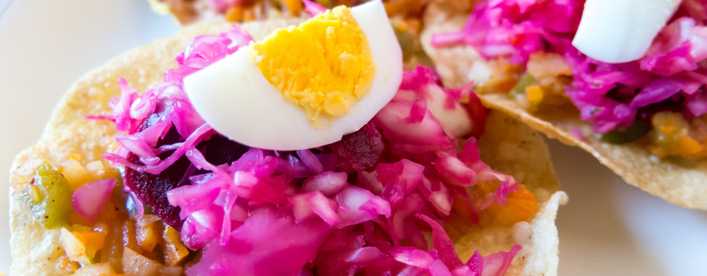 ## Traditional dishes of Guatemala

Guatemala is a country with an incredible gastronomic richness characterized by its variety of ingredients and its colorful and ancestral recipes. Divided into 7 major regions with different culinary cultures, ingredients and traditions, the country offers a range of foods that satisfy the needs of anyone who visits it. You can't miss out on the food that characterizes traditional Guatemalan cuisine, here is a list of dishes you should try on your next trip to Guatemala.

![gastronomia-en-guatemala.png](https://cdn.travelisimo.com/gastronomia_en_guatemala_0acc56df91)

## Pepián

It’s a soup originally from western Guatemala, made with chiles, tomato, various spices and bread. This traditional dish has been made since the XVI century and throughout time different varieties of this dish have been created. You can taste it in any tourist site in the country, such as Antigua Guatemala or Atitlán. If tasting the local Guatemalan food is important in your trip, pepián is a dish you can't miss in your visit to Guatemala.

Learn how to prepare your own [Pepián](https://www.travelisimo.com/guatemala/blog/posts/como-hacer-pepian-receta-guatemalteca?country=GT)

![pepian-gastronomia-guatemala.png](https://cdn.travelisimo.com/pepian_gastronomia_guatemala_d39e71d374) 

## Jocón
This dish is an original recipe from Huehuetenango, characterized by its unmistakable green color and delicious flavor. Like the pepian, this dish has spread throughout Guatemala, and each region of the country has its own way of making it. That is why no matter where you try this dish, it will always be a different experience.

![jocon-gastronomia-guatemala.png](https://cdn.travelisimo.com/jocon_gastronomia_guatemala_7b094794a0)

## Tamales

The tamale is a dish found in many Latin American countries, and Guatemala is no exception. Made from corn, the Guatemalan tamale has a peculiar reddish color that differentiates it from others, this is because of the delicious red filling with which the dish is prepared. The preparation of tamales is usually a long and laborious process, so it is a food that is prepared only for celebrations or ceremonies. Especially if you travel to Guatemala in the month of December or January you will find tamales all over the place, since it is very common for the end of the year celebrations to share tamales among Guatemalans.

![tamal-gastronomia-guatemala.png](https://cdn.travelisimo.com/tamal_gastronomia_guatemala_a1389edd4e)

## Plantains in mole

This dish is a very peculiar Guatemalan dessert, made with plantains, chocolate and spices. Its spicy flavor and the contrast with the sweetness of the chocolate characterizes it and gives it relevance in the culinary culture of the country. Made since the XVI century, mole has become an Intangible Cultural Heritage of the Nation among other traditional dishes. If you have a sweet tooth, you can't miss this dessert during your visit to Guatemala.

![platanos-en-mole-gastronomia-guatemala.png](https://cdn.travelisimo.com/platanos_en_mole_gastronomia_guatemala_8d82628a92)

## Fiambre

The "fiambre" is a dish that has been made in Guatemala since the XVI century. This dish is mainly consumed on All Saints' Day, November 1st of each year. The recipe for this dish varies in each house and at each table, but the base is always the same: sausages, cheeses, vegetables and meats. This dish has become one of the greatest traditions for Guatemalan families, since the fiambre is more than a dish, it is a celebration. If you are in Guatemala at this time of the year, we recommend you to try the "fiambre" and live the tradition with the Guatemalans.

![fiambre-gastronomia-guatemala.png](https://cdn.travelisimo.com/fiambre_gastronomia_guatemala_6ee7801643)

## Atoles

Just as there are many delicious foods in Guatemalan cuisine, there are many beverages that complement these dishes. Among the most traditional drinks in Guatemala are atoles made from a wide variety of ingredients. Some of the main ones are: atol de elote, atol de haba, arroz con leche, atol de plátano, atol shuco, atolillo, atol de Ixpasá, among others. Many of these hot drinks are of ancestral origin and their recipes have been passed down through generations to this day. You can find these traditional drinks in fairs, markets and even in the streets of the country on your next trip.

![atol-de-elote-gastronomia-guatemala.png](https://cdn.travelisimo.com/atol_de_elote_gastronomia_guatemala_ffea18f9d4)
___


Discover more about the gastronomy of Guatemala and Central America in our [Travelisimo blogs](https://travelisimo.com/guatemala/blog). 

All your travel needs in one place
Travelisimo


