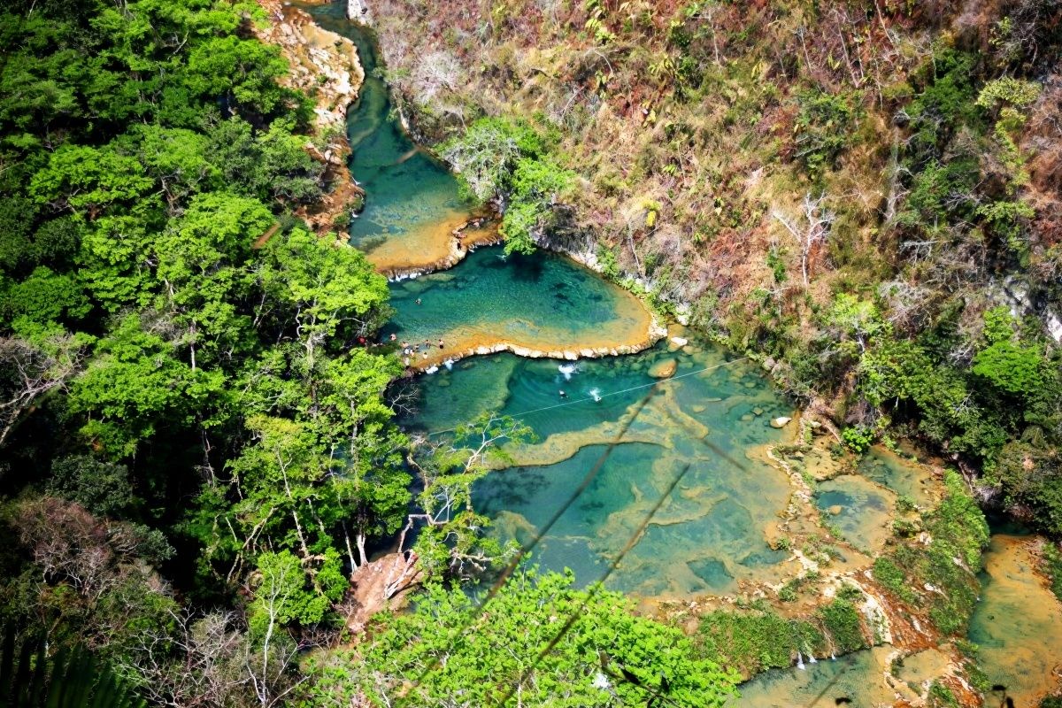 Turquoise cascading natural pools at Semuc Champey, Lanquín, Verapaces, with crystal-clear waters, limestone bridges and jungle vegetation