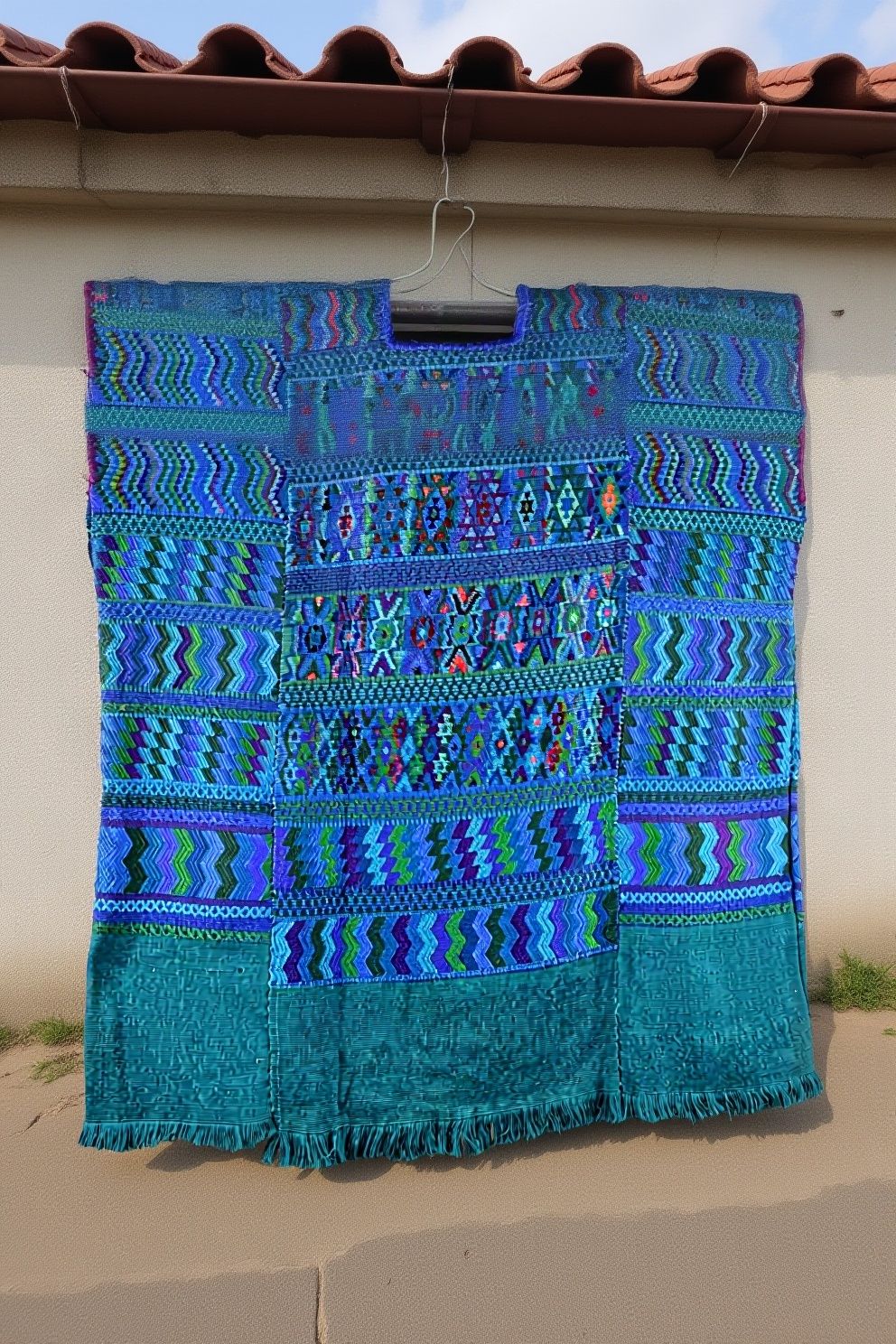 Traditional Santa Catarina Palopó huipil with indigo blue, hand-woven geometric patterns and turquoise fringe, Sololá Guatemala